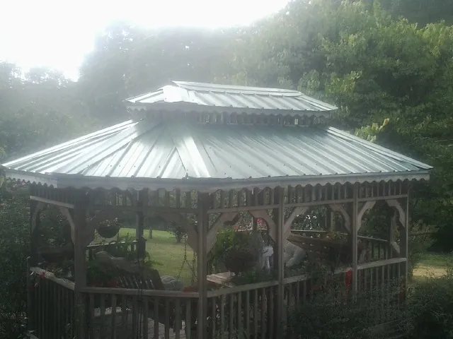 Two tier green metal roof on a garden gazebo in Calabash